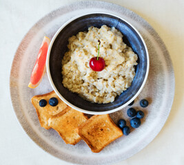 Healthy breakfast. Oat Flakes Porridge with toasts.