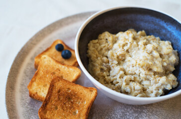 Healthy breakfast. Oat Flakes Porridge with toasts.