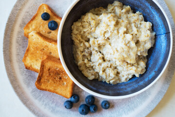 Healthy breakfast. Oat Flakes Porridge with toasts.