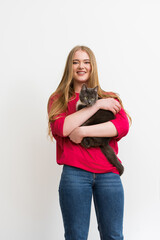 happy young woman holding in arms fluffy cat isolated on white