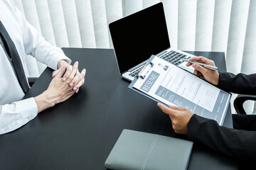 Office executives are interviewing job applicants in the meeting room