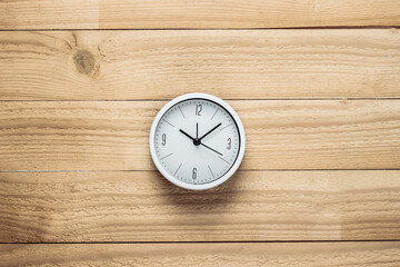 White clock on wooden boards. Repair time. Top view