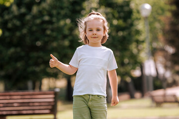 Blond children play and have fun on a sunny day in the park..