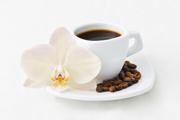 Coffee cup with coffee beans and orchid flower. Composition Coffee cup for breakfast. Concept business morning at spa salon. Coffee break.