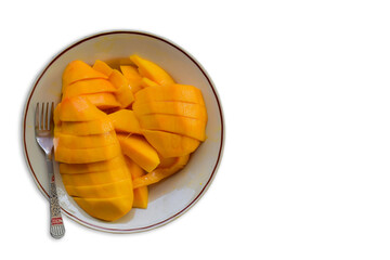 Mango ripe yummy on a dish with a fork on white background isolated.