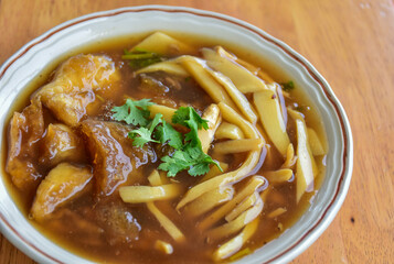 Braised fish maw soup in red gravy include vagetable bamboo shoot on background chinese and asian.