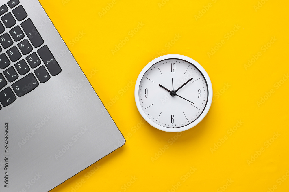 Poster laptop and alarm clock on yellow background. time running away. the concept of urgent deadlines at w