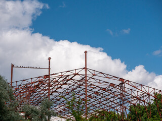 Construction of a huge red frame for a shopping center near the city.