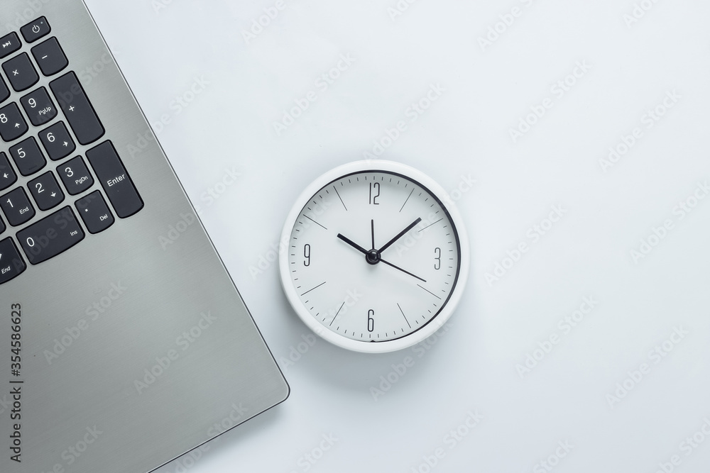 Poster laptop and clock on white background. time running away. the concept of urgent deadlines at work and