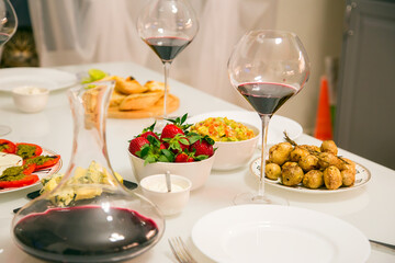  Table setting with red wine and strawberries.Horizontally.