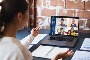 Asian woman virtual conference meeting video call and work at home office