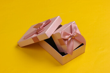 Gift boxex on yellow background close up.