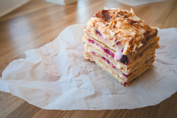 Homemade layer cake with raspberries on parchment