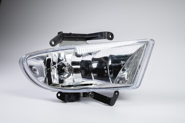 A one of new embedded in the front bumper fog lights on a gray background. New modules of additional lighting spare parts for the car © yanik88