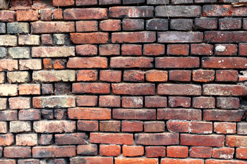 A dirty brick wall of an old rural building under reconstruction in the Central Bohemian Region. Closeup.