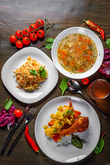 lunch set made of three meals, such as soup, vegetables salad and chicken with vegetables