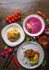 lunch set made of three meals, such as soup, vegetables salad and meat with mashed potato