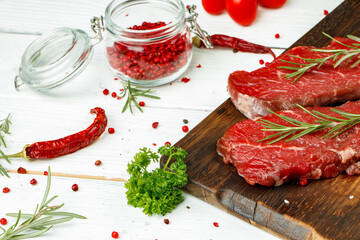 Barbecue veal steaks with rosemary on wooden board