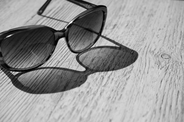 Black and white Sunglasses isolated on a wooden background