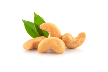 Roasted cashew nuts with green leaves isolated on white.