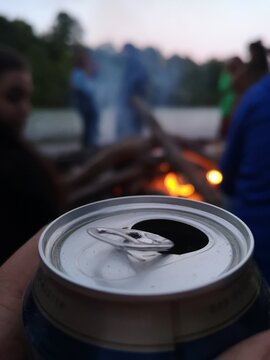 Close up of a tin can in front of camp fire