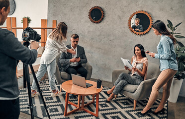 Female journalist interviewing business man