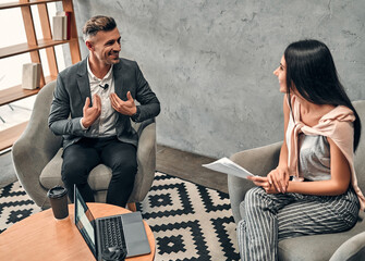 Female journalist interviewing business man