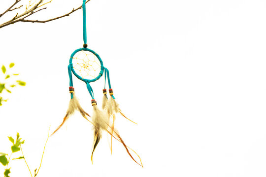 Dream catcher close-up on a white sky background. Blurred background.
