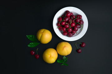 Peaches and cherries on a white dinner plate