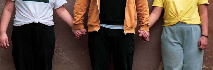 father holding his kids by the hands