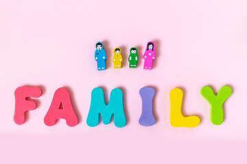 Word family and wooden figures of people on pink background.