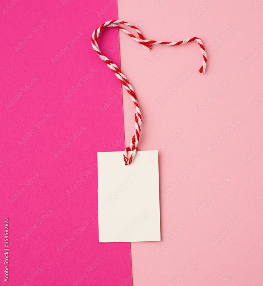 Poster white paper rectangular tag on a rope on a colored background