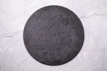 Round slate stand on a gray background