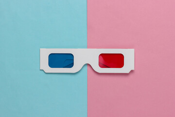 Retro 80s paper stereo 3D glasses with red-blue eye filters on a blue-pink pastel background. Top...