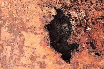 background of old rusty iron texture with a big hole