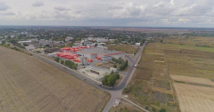 Exterior of new factory. dern factory in gray-orange colors from the air. Flight near modern factory