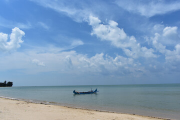 Fototapeta na wymiar Boat on the ocean. Tanjung Tinggi Beach, Belitung, Bangka Belitung island, Indonesia