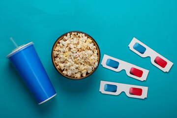 Movie time. Stereoscopic anaglyph disposable paper 3d glasses, paper cup of drink and popcorn bowl...