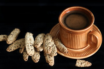 still life of unusually tasty salt dough crackers with bran and caraway seeds and a cup of coffee. cooked according to an exclusive recipe