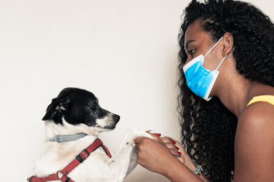 Girl Going Out With Her Dog, With All Prevention. Young Girl Worries About Coronavirus.Time To Go Out With Her Pet, With Mask. Covid 19 Concept.  Image