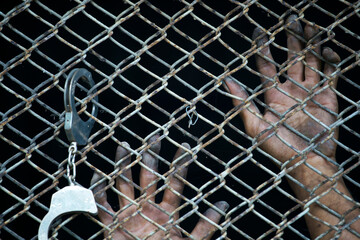 Fototapeta na wymiar close up of prisoner hand in jail