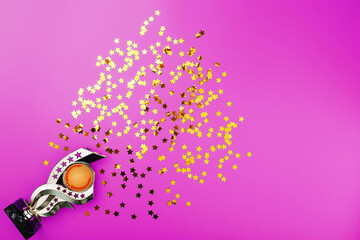 Superprize of gold with fireworks of stars on a pink background.