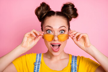 Close-up portrait of her she nice attractive pretty amazed lucky funky cheerful cheery brown-haired girl touching specs good news sale discount reaction isolated over pink pastel color background
