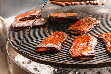 Smoked ribs grilled meat on a grid outside