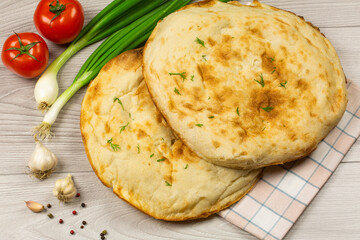 Fresh homemade pita with tomatoes and spices. Cooking concept