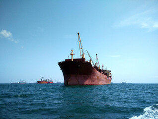 A large cargo ship floating in the middle of the sea