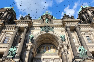 Berlin Cathedral. Black birds flock over city. © Tupungato