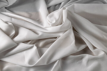 White fine chiffon fabric with a woven texture. Gathered in a spiral and crushed textiles. Silky...