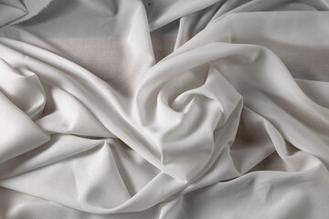Naklejka na ściany i meble White fine chiffon fabric with a woven texture. Gathered in a spiral and crushed textiles. Silky light and airy surface.