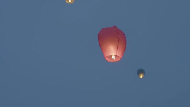 Chinese lanterns lifting up in the sky. Celebration, holidays, making a wish